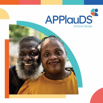 An older man with a grey beard and a smiling woman with Down syndrome photographed together outdoors, with the APPlauDS Clinical Study logo above them.